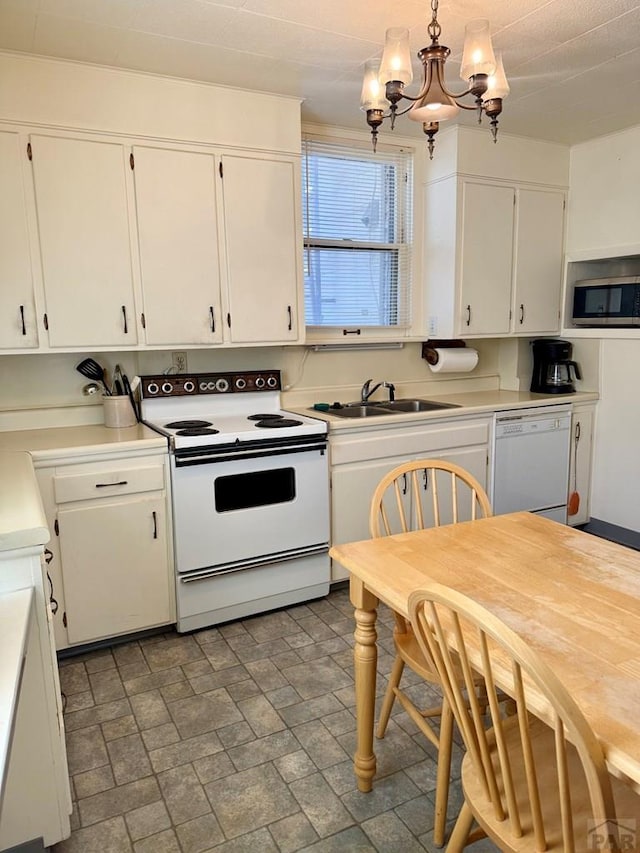 602 Belleview Ave, La Junta, CO 81050 - kitchen with white appliances, a sink, white cabinets, and a chandelier