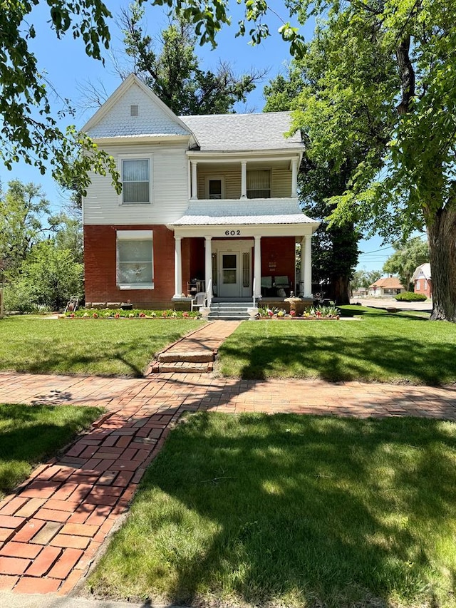 602 Belleview Ave, La Junta, CO 81050 - view of front of home with covered porch and a front yard