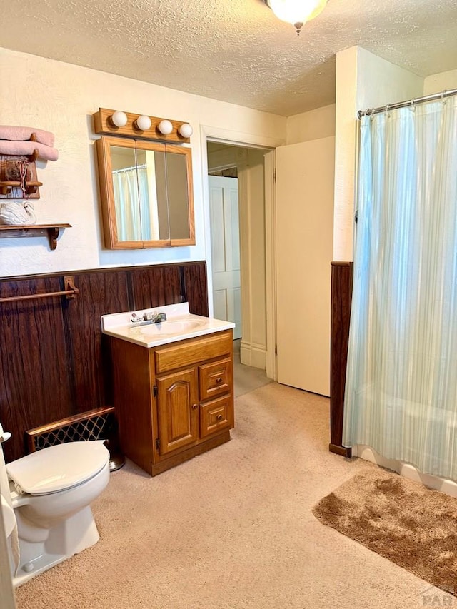 602 Belleview Ave, La Junta, CO 81050 - full bathroom with a textured ceiling, vanity, toilet, and a shower with shower curtain
