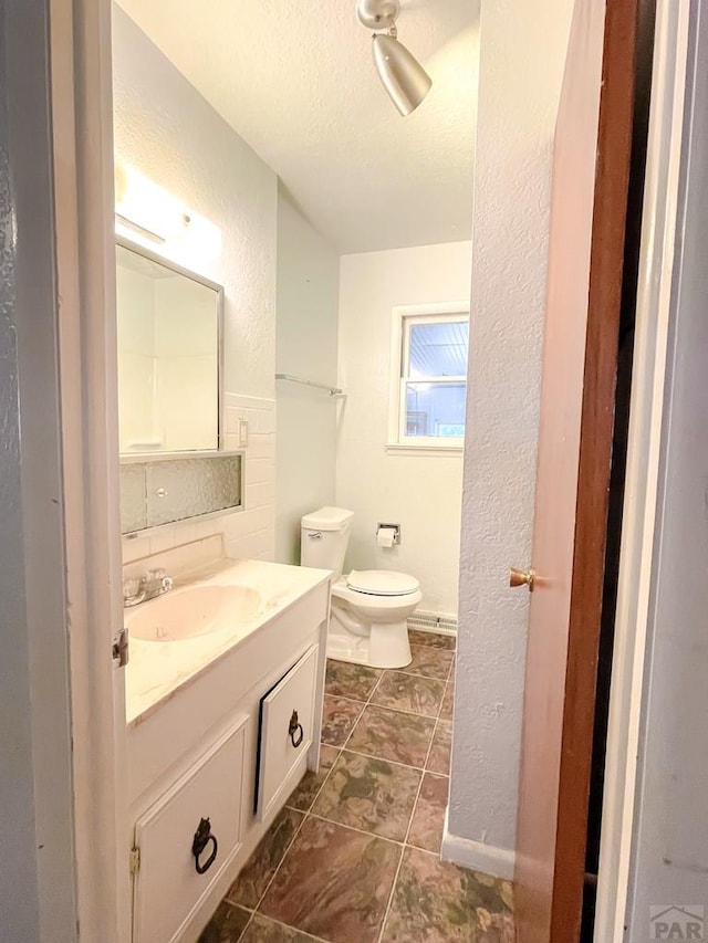 735 Poplar Ave, Las Animas, CO 81054 - bathroom with a textured wall, vanity, a textured ceiling, and tile patterned flooring