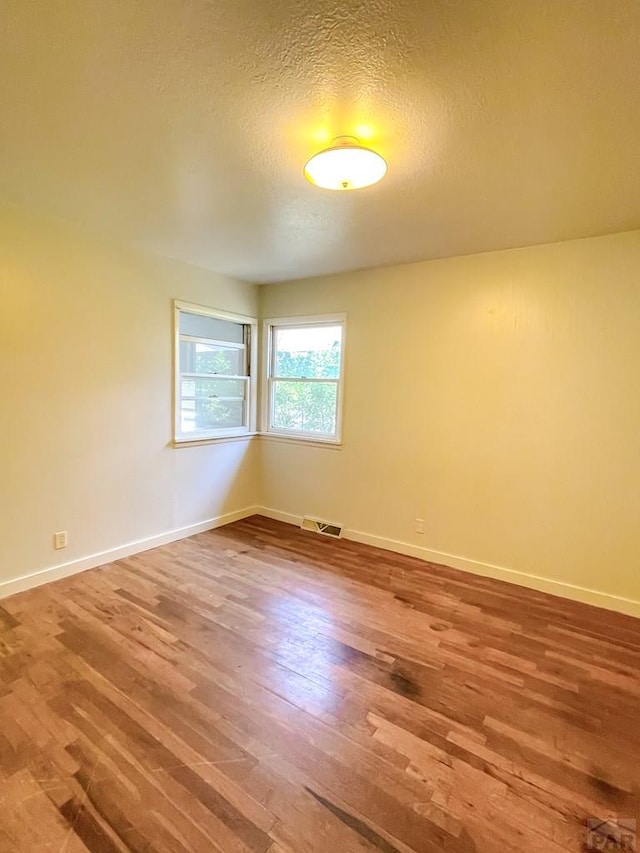 735 Poplar Ave, Las Animas, CO 81054 - empty room featuring wood finished floors and a textured ceiling