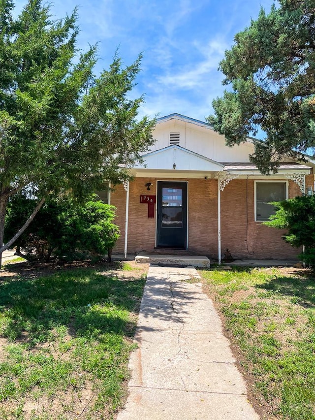 735 Poplar Ave, Las Animas, CO 81054 - view of front facade with covered porch and brick siding