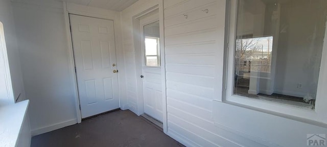 interior space with finished concrete flooring and baseboards