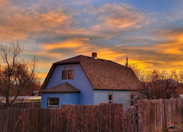 801 N Hendren Ave, Walsenburg, CO 81089 - property exterior at dusk with stucco siding and a shingled roof