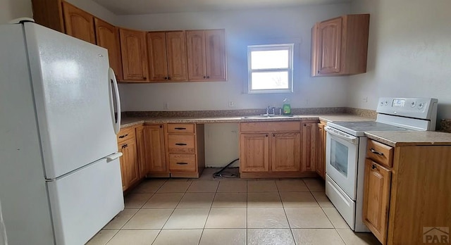 kitchen with white appliances, light countertops, a sink, and light tile patterned flooring