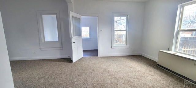 unfurnished bedroom with baseboards and light colored carpet