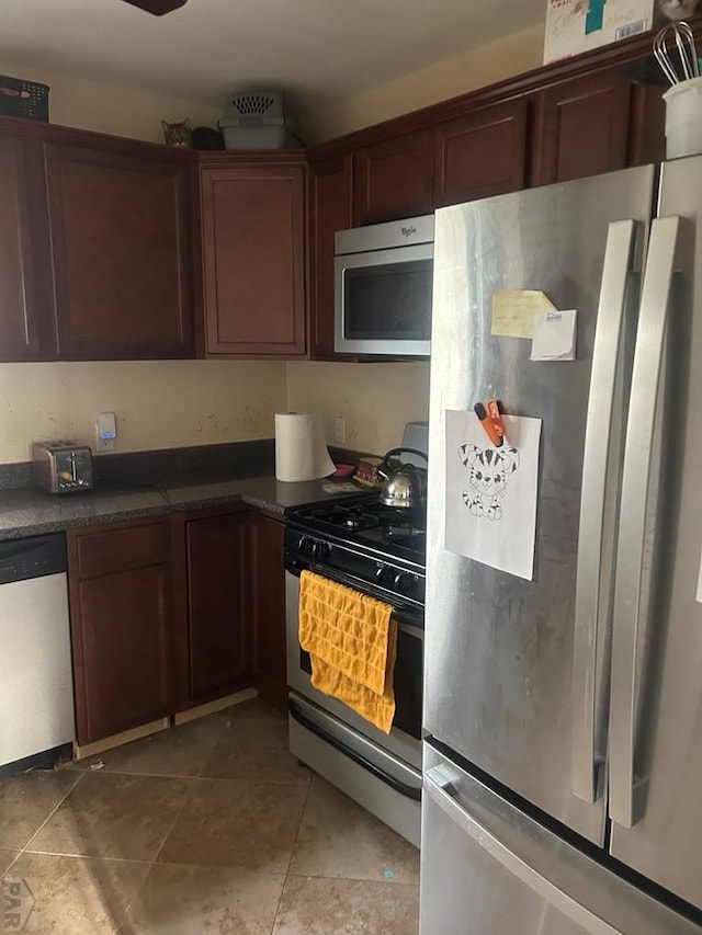 kitchen featuring dark countertops and appliances with stainless steel finishes