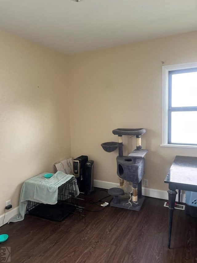 bedroom with baseboards and wood finished floors