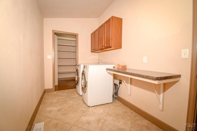 5707 Mark Twain Ln, Pueblo, CO 81008 - laundry room featuring separate washer and dryer, cabinet space, and light tile patterned floors