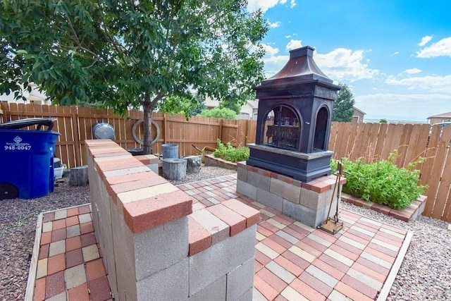 5707 Mark Twain Ln, Pueblo, CO 81008 - fenced backyard with a patio area and a multi sided fireplace