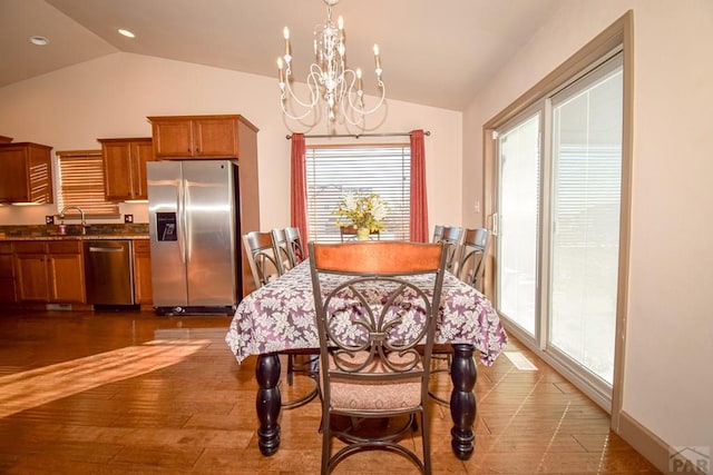 5707 Mark Twain Ln, Pueblo, CO 81008 - dining space with lofted ceiling, a chandelier, recessed lighting, and dark wood-style floors