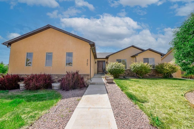 5707 Mark Twain Ln, Pueblo, CO 81008 - view of front of property with a front lawn, stucco siding, and stone siding