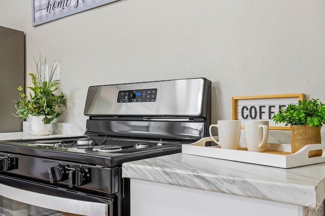 interior details with light countertops and stainless steel range with gas cooktop