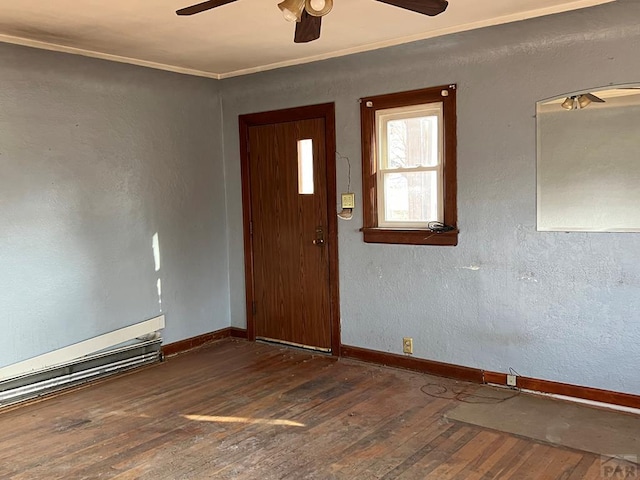 spare room with wood-type flooring, baseboards, ceiling fan, and crown molding