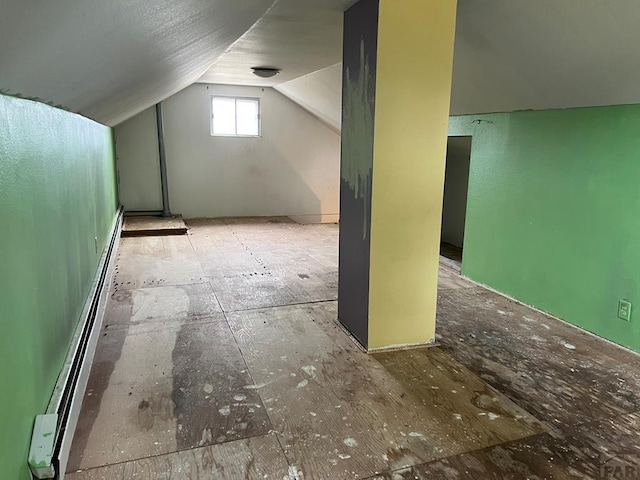 bonus room with a baseboard heating unit and vaulted ceiling