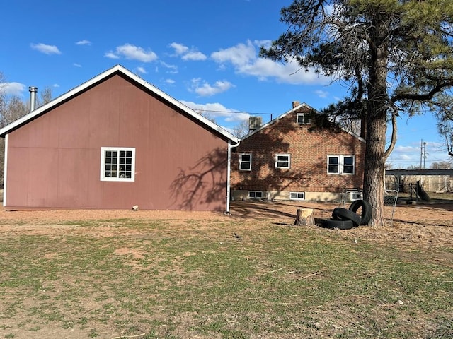 view of side of home with a yard