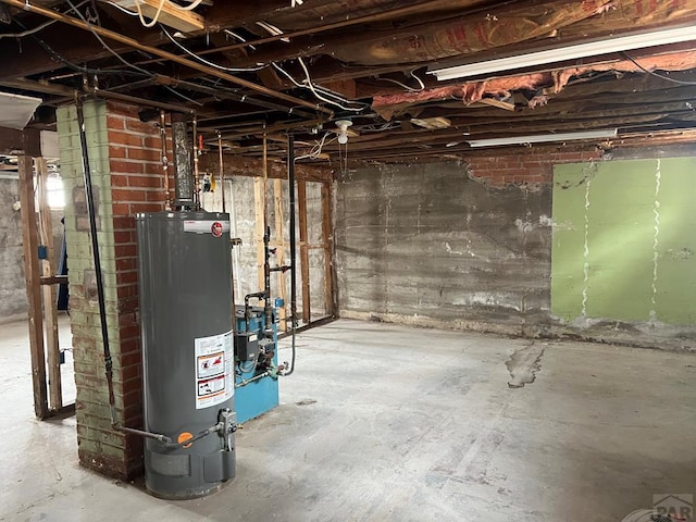 unfinished basement featuring water heater