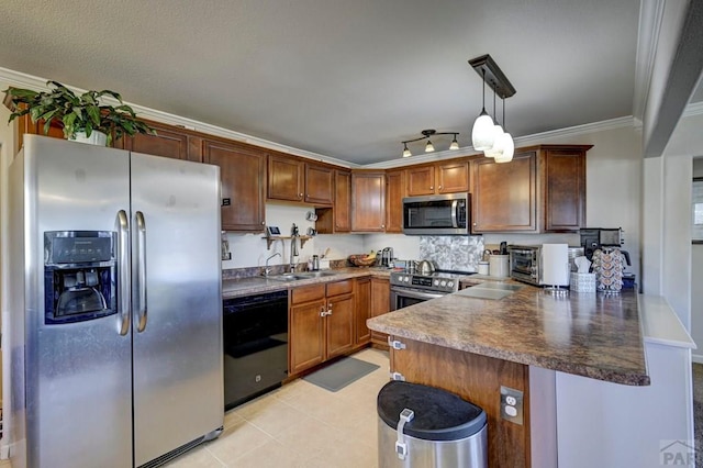 kitchen featuring stainless steel appliances, a peninsula, hanging light fixtures, dark countertops, and crown molding