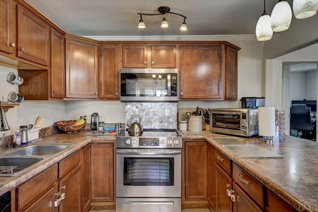 kitchen with a toaster, crown molding, appliances with stainless steel finishes, brown cabinets, and pendant lighting