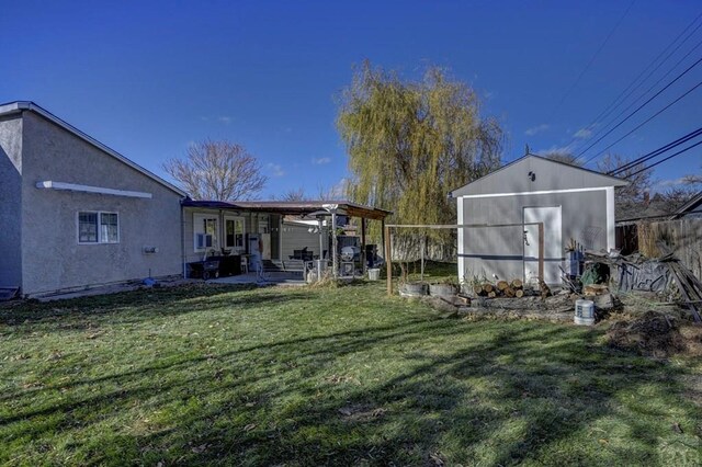 view of yard with fence and an outdoor structure