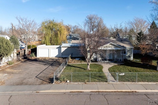 ranch-style house with a fenced front yard, a residential view, and a front lawn