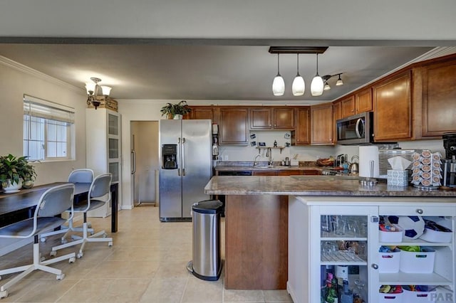 kitchen with light tile patterned floors, ornamental molding, appliances with stainless steel finishes, brown cabinetry, and decorative light fixtures