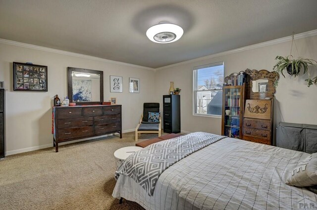 bedroom with crown molding, baseboards, and light colored carpet