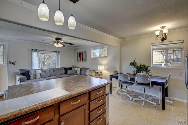 kitchen with pendant lighting, crown molding, light tile patterned floors, brown cabinetry, and open floor plan