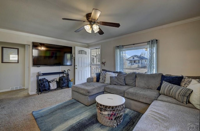 living area featuring ceiling fan, carpet floors, visible vents, baseboards, and crown molding