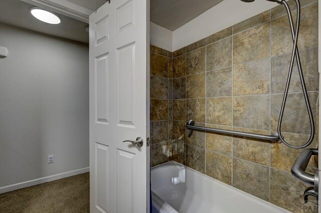 full bathroom with shower / bath combination and baseboards