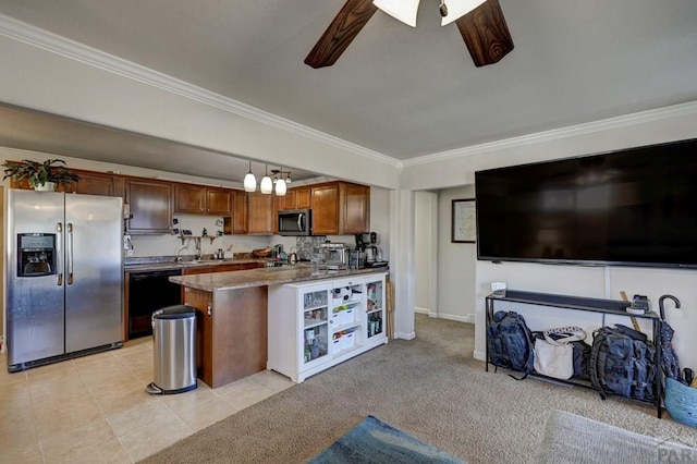 kitchen featuring brown cabinetry, appliances with stainless steel finishes, open floor plan, ornamental molding, and hanging light fixtures