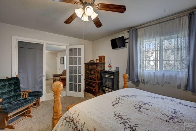 bedroom featuring ceiling fan, carpet flooring, and french doors