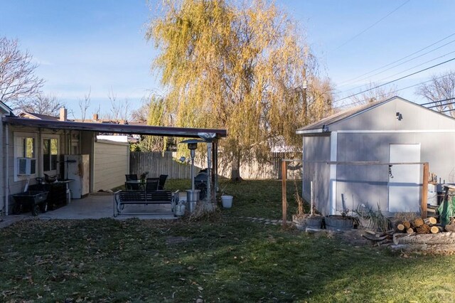 view of yard with a storage unit, an outdoor structure, and fence