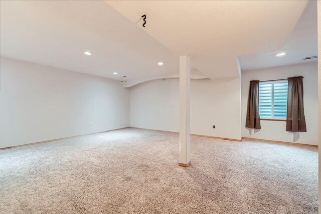 below grade area featuring carpet, visible vents, baseboards, and recessed lighting