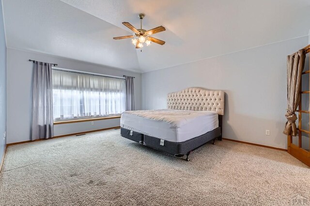 bedroom featuring carpet, visible vents, vaulted ceiling, ceiling fan, and baseboards