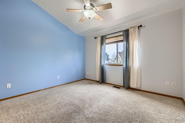 unfurnished room featuring ceiling fan, carpet flooring, visible vents, baseboards, and vaulted ceiling