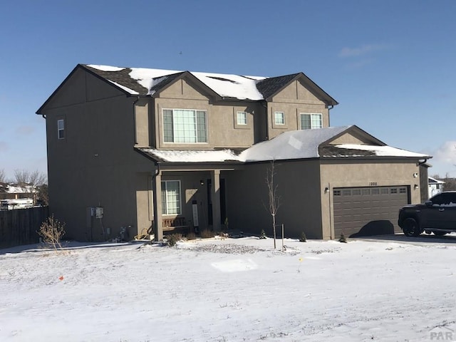 view of front facade with a garage and stucco siding