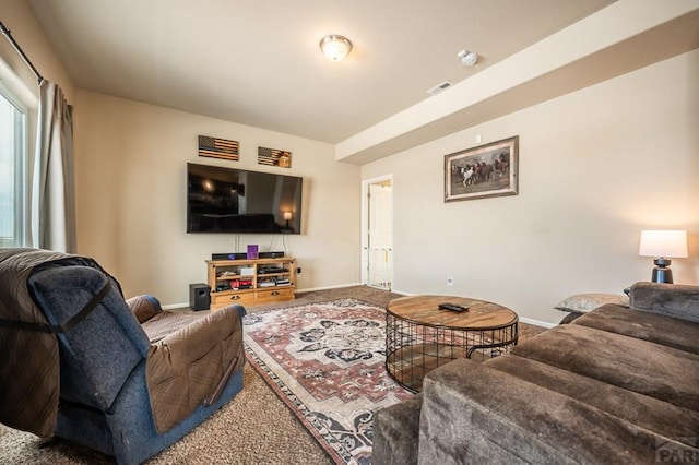 living room with visible vents, baseboards, and carpet floors