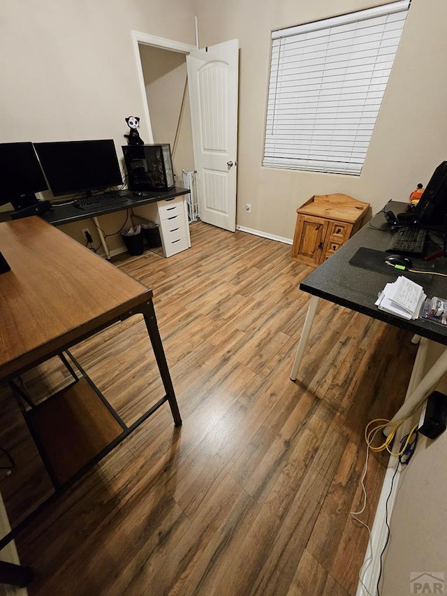 home office featuring wood finished floors and baseboards