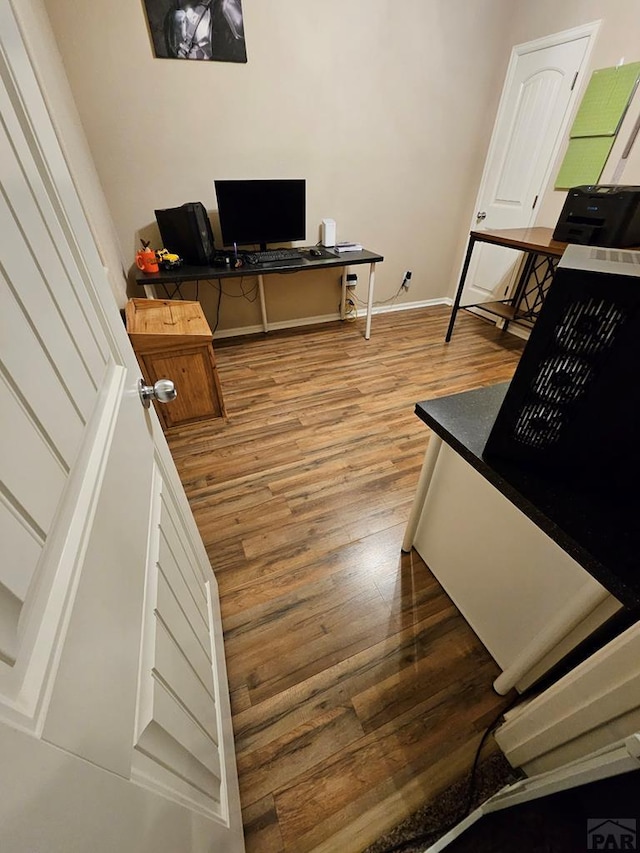 office area featuring baseboards and wood finished floors