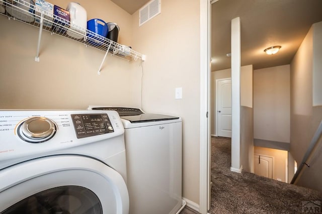 washroom with laundry area, carpet floors, visible vents, baseboards, and washer and clothes dryer