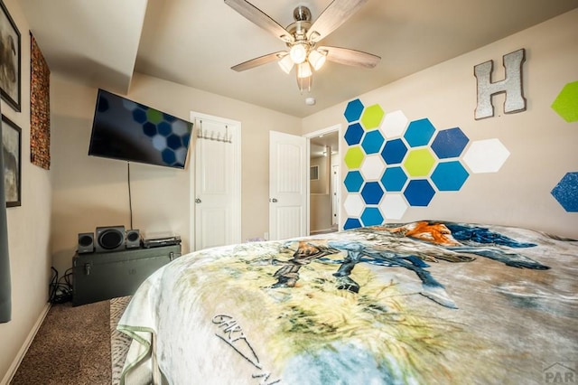 bedroom with ceiling fan, baseboards, and carpet flooring