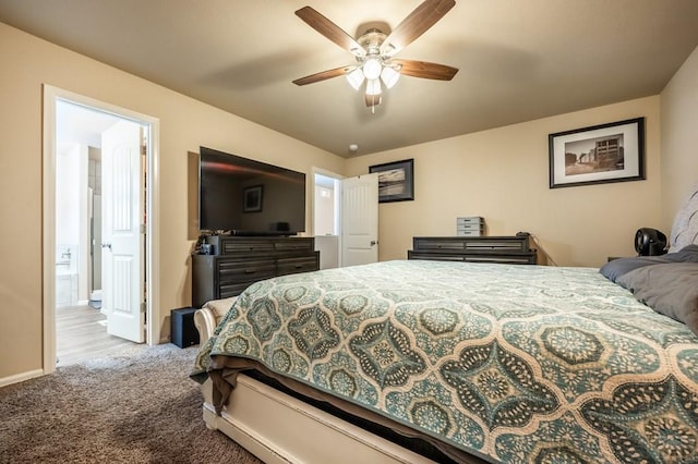 carpeted bedroom with ceiling fan and baseboards