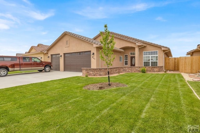 view of front of home featuring an attached garage, a front lawn, concrete driveway, and stucco siding