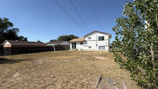 back of house with fence