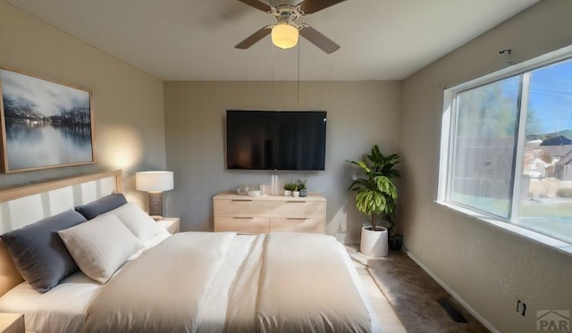 bedroom featuring a ceiling fan and baseboards