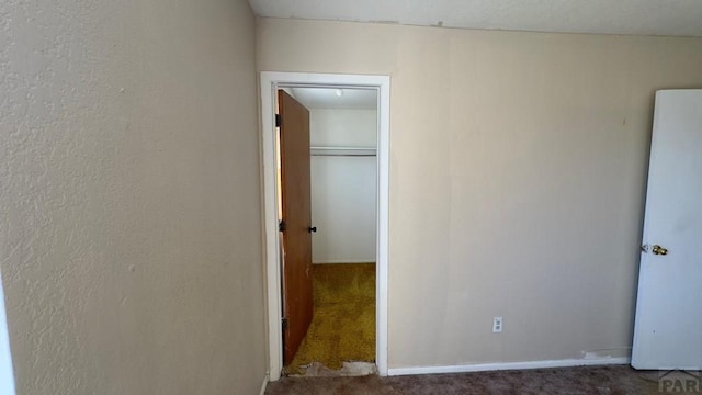 unfurnished bedroom with carpet floors and baseboards