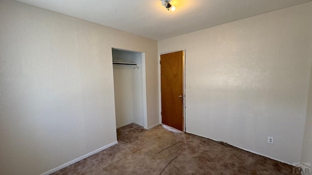 unfurnished bedroom with a closet and light carpet