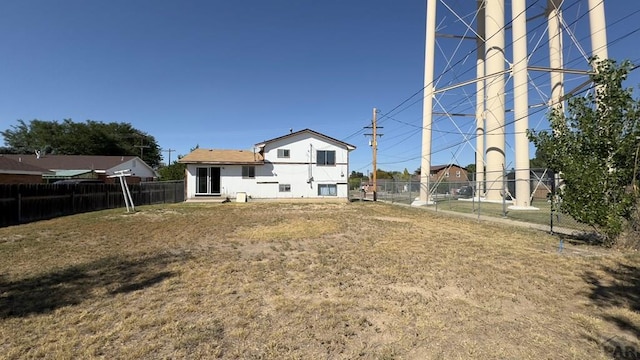 back of property featuring fence and stucco siding