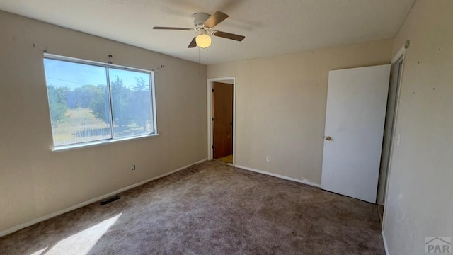 unfurnished bedroom with ceiling fan, carpet flooring, visible vents, and baseboards